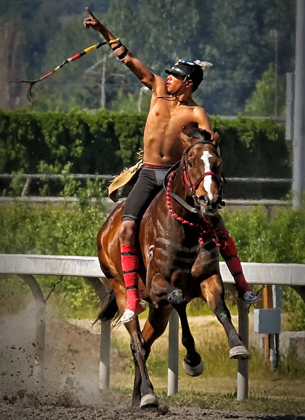 Indian Relay Horse Race rider raising his arm in triumph